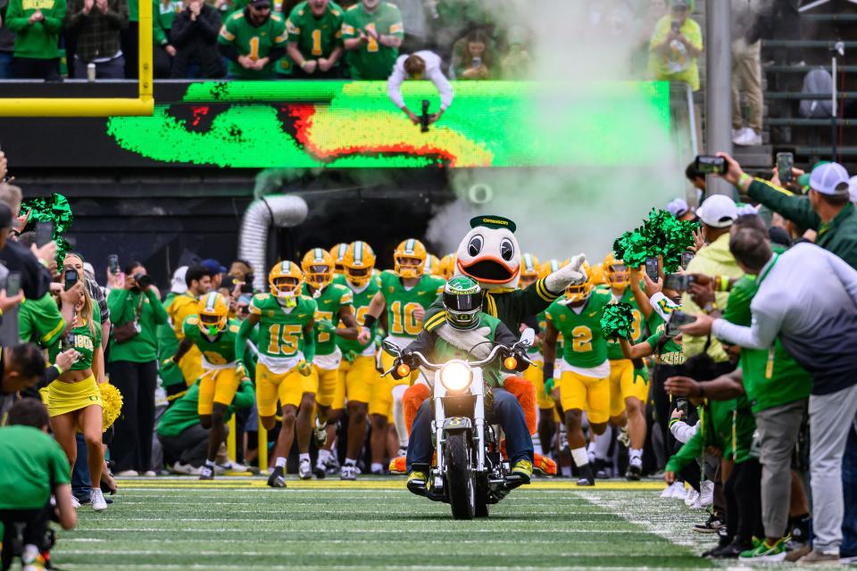 Oct 21, 2023; Eugene, Oregon, USA; Oregon Ducks mascot The Duck leads the team entrance against the Washington State Cougars at Autzen Stadium. Mandatory Credit: Craig Strobeck-USA TODAY Sports