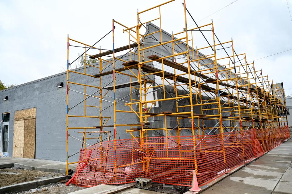 Scaffolding around the outside of Moneyball Sportswear's new headquarters on Tuesday, May 2, 2023, in Lansing.