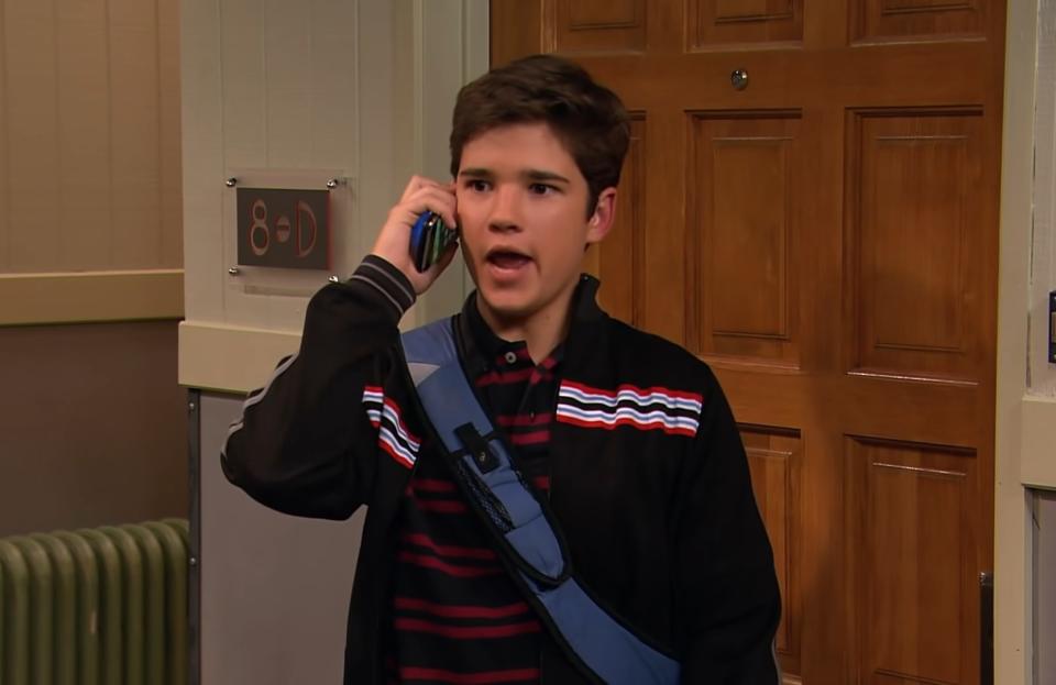 Nathan Kress talks on mobile phone with someone