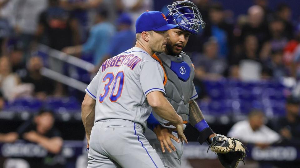 Mar 30, 2023;  Miami, Florida, USA;  New York Mets relief pitcher David Robertson (30) celebrates with catcher Omar Narvaez (2) after winning the game against the Miami Marlins at loanDepot Park.