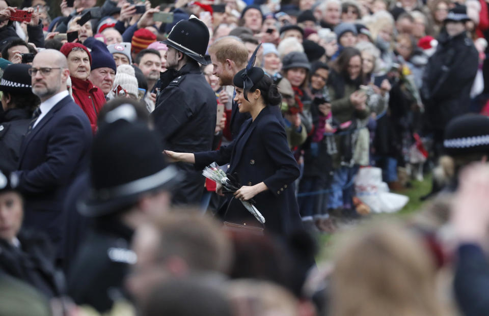 Britain's Prince Harry and Meghan, Duchess of Sussex meet members of the crowd after attending the Christmas day service at St Mary Magdalene Church in Sandringham in Norfolk, England, Tuesday, Dec. 25, 2018. (AP Photo/Frank Augstein)