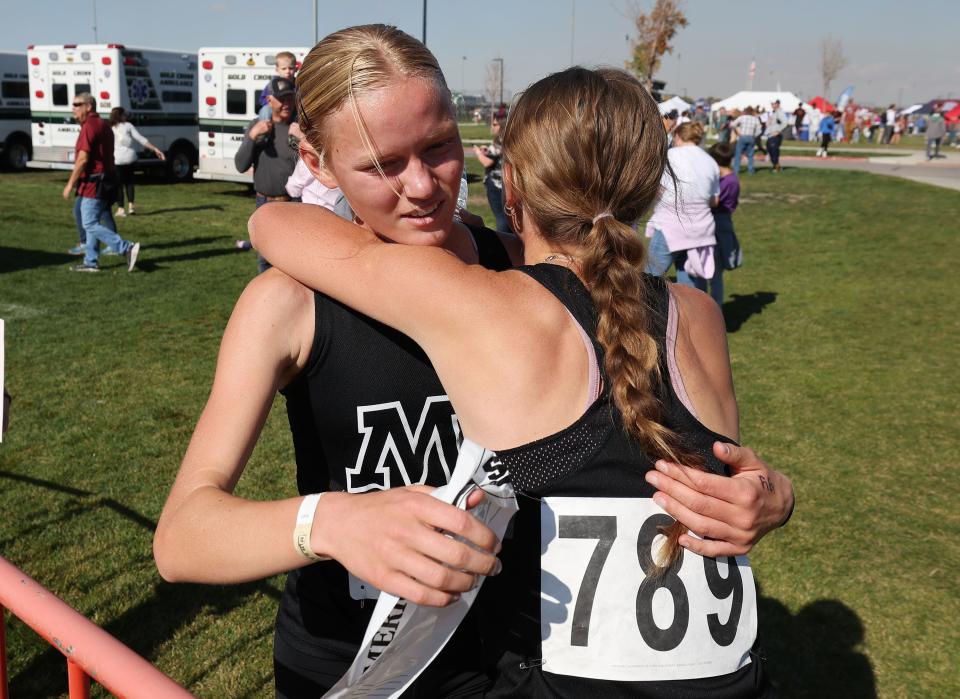 Julie Moore of Mountain View, left, hugs a teammate after winning the 4A girls cross-country state championship race at the Regional Athletic Complex in Rose Park on Tuesday, Oct. 24, 2023. | Jeffrey D. Allred, Deseret News