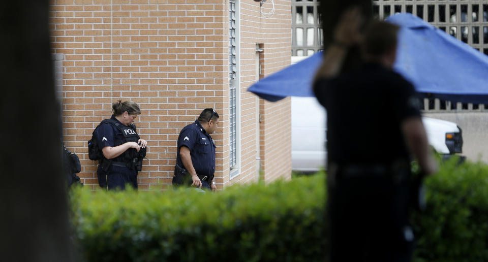 Dallas police respond to reports of a suspicious person in the parking garage of police headquarters in Dallas