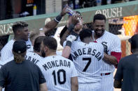 The Chicago White Sox celebrate around Tim Anderson after Anderson scored the winning in the 10th inning of a baseball game against the Seattle Mariners Wednesday, Aug. 23, 2023, in Chicago. The Chicago White Sox won 5-4. (AP Photo/Charles Rex Arbogast)