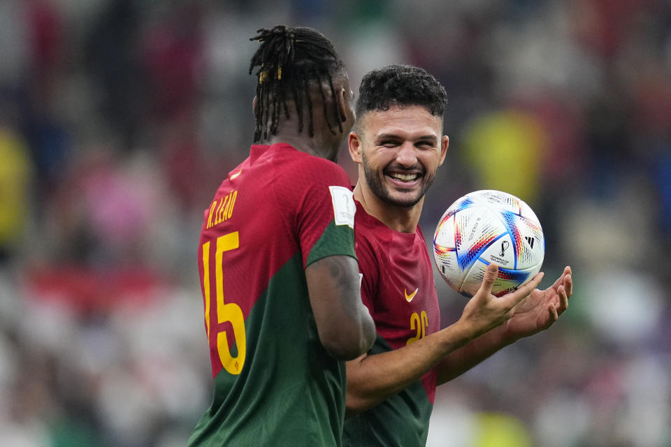 Portugal's Rafael Leao, left, and Portugal's Goncalo Ramos celebrate after the win during the World Cup round of 16 soccer match between Portugal and Switzerland, at the Lusail Stadium in Lusail, Qatar, Tuesday, Dec. 6, 2022. (AP Photo/Natacha Pisarenko)