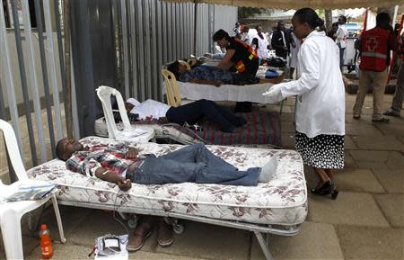 Members of the public donate blood at a temporary donation centre for the injured victims of a crossfire between armed men and the police at the Westgate shopping mall, in Kenya's capital Nairobi September 22, 2013. REUTERS/Thomas Mukoya (KENYA - Tags: CIVIL UNREST CRIME LAW)