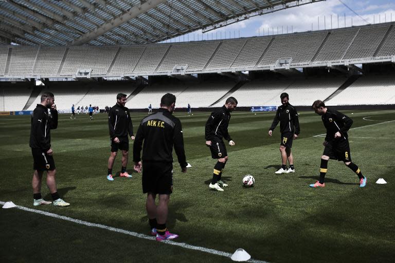 AEK Athens FC players warm up on April 4, 2015 before a game of the Greek football league against Alimos FC at OAKA Stadium in Athens