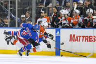New York Rangers defenseman Braden Schneider (4) crashes into Philadelphia Flyers left wing Noah Cates (27) during the first period of an NHL hockey game Thursday, April 11, 2024, at Madison Square Garden in New York. (AP Photo/Mary Altaffer)