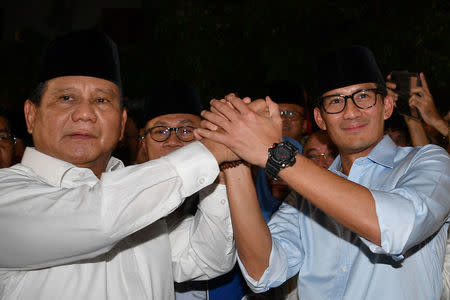 Gerindra Party Chairperson Prabowo Subianto (L) and Jakarta Deputy Governor Sandiaga Uno announce their bid in the 2019 presidential elections in Jakarta, Indonesia August 9, 2018 in this photo taken by Antara Foto. Picture taken August 9, 2018. Antara Foto/Sigid Kurniawan/ via REUTERS