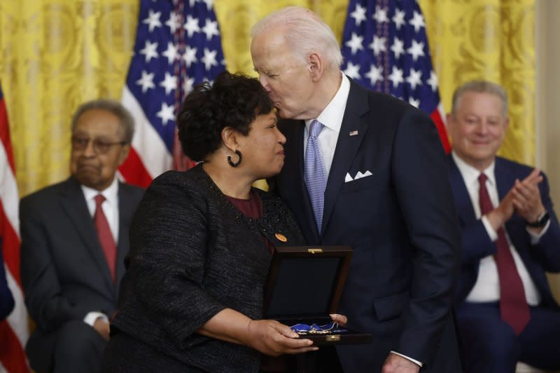 President Joe Biden kisses Reena Evers, daughter of civil-rights crusader Medgar Evers, with the Presidential Medal of Freedom, the nation's highest civilian honor, during a ceremony in the East Room of the White House in Washington, D.C., on Friday. Photo by Jonathan Ernst/UPI