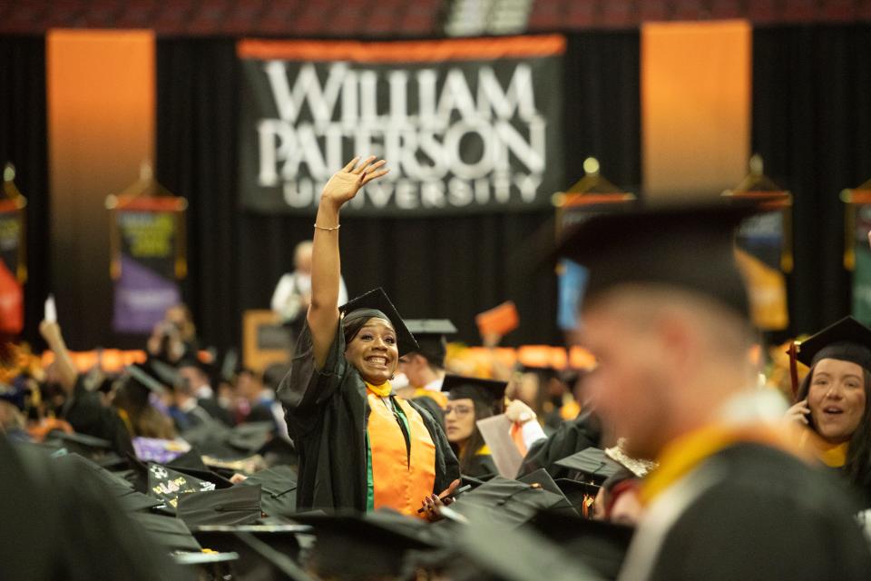 A graduate waves to her family. The undergraduate commencement ceremony for William Paterson University 2022 graduating class was held at the Prudential Center in Newark, N.J. on Wednesday May 18, 2022. 
