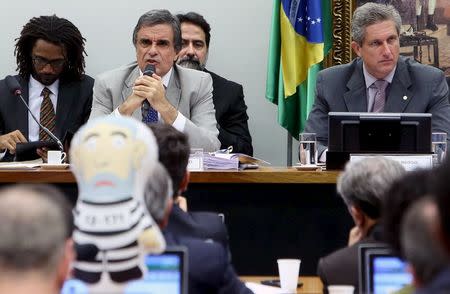 Brazil's General Attorney Jose Eduardo Cardozo (2nd L) speaks while a congressman holds an inflatable doll known as "Pixuleco" depicting Brazil's former President Luiz Inacio Lula da Silva during the session of the impeachment committee against Brazilian President Dilma Rousseff in Brasilia, Brazil, April 4, 2016. REUTERS/Adriano Machado