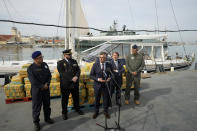 Portuguese police chief Luis Neves, center, addresses the media in front of bales of cocaine weighting some 5,2 tons and a seized yacht at a Portuguese Navy base in Almada, south of Lisbon, Monday, Oct. 18, 2021. Portuguese police said Monday the seizure was the largest in Europe in recent years and the biggest in Portugal for 15 years. Police localized and intercepted the 24-meter (79-foot) yacht at sea. The operation involved police from Portugal, Spain, the Drug Enforcement Agency in the United States and the United Kingdom's National Crime Agency. (AP Photo/Armando Franca)