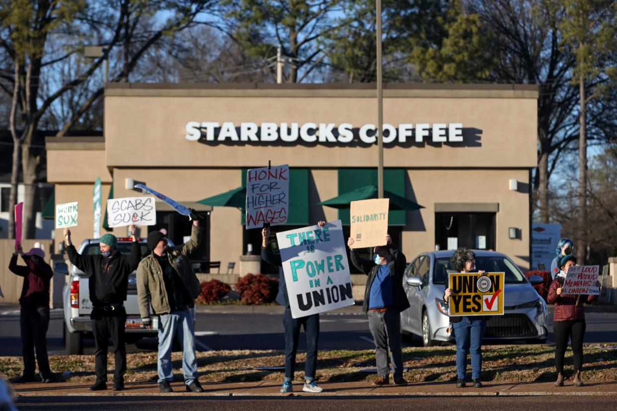 Pro-union demonstrators stand outside of a Starbucks on Poplar Avenue in Memphis, Tenn. where several workers were fired on Tuesday, Feb. 8, 2022. 