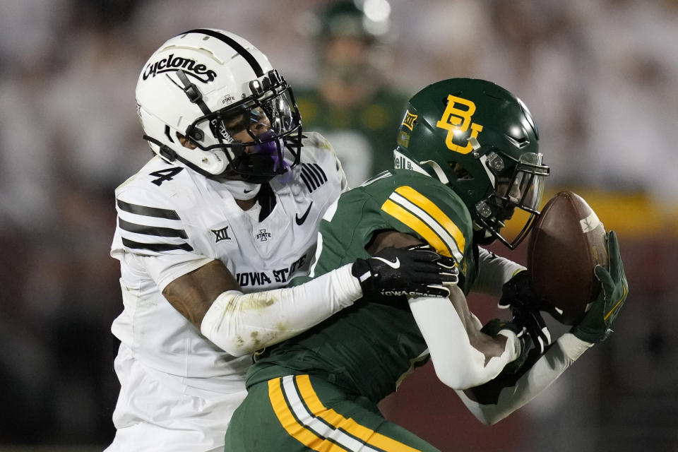 Iowa State defensive back Jeremiah Cooper (4) breaks up a pass intended for Baylor wide receiver Ashtyn Hawkins, right, during the first half of an NCAA college football game, Saturday, Oct. 5, 2024, in Ames, Iowa. (AP Photo/Charlie Neibergall)