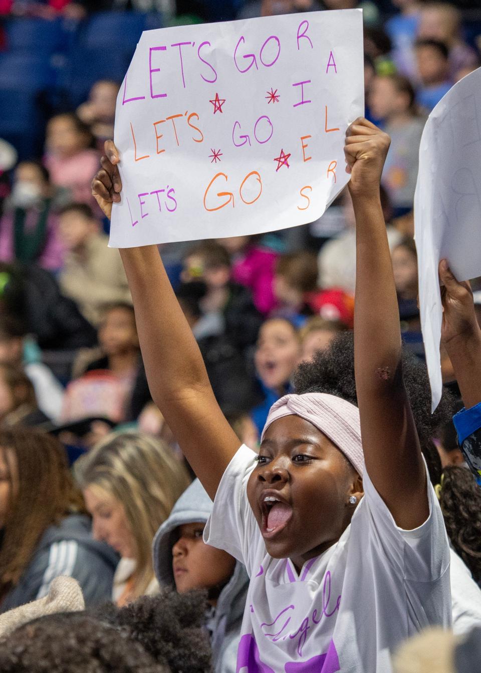 Clark Street School fifth-grader Masona Kanneh and hundreds of other Worcester Public Schools students cheer for the Railers during a morning hockey game at the DCU Center Wednesday, November 29, 2023.
