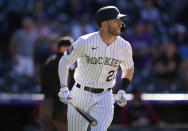 Colorado Rockies Trevor Story follows the flight of his walkoff, solo home run off Arizona Diamondbacks relief pitcher Stefan Crichton in the ninth inning of a baseball game Sunday, May 23, 2021, in Denver. The Rockies won 4-3. (AP Photo/David Zalubowski)