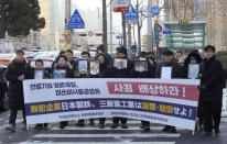 Family members of forced labor victims during the Japan's colonial period, arrive at the Supreme Court in Seoul, South Korea, Thursday, Dec. 21, 2023. The sign reads "Mitsubishi Heavy Industries should compensate and apologize." South Korea’s top court ordered two Japanese companies to financially compensate more of their wartime Korean workers for forced labor, as it sided Thursday with its contentious 2018 verdicts that caused a huge setback in relations between the two countries.(AP Photo/Ahn Young-joon)