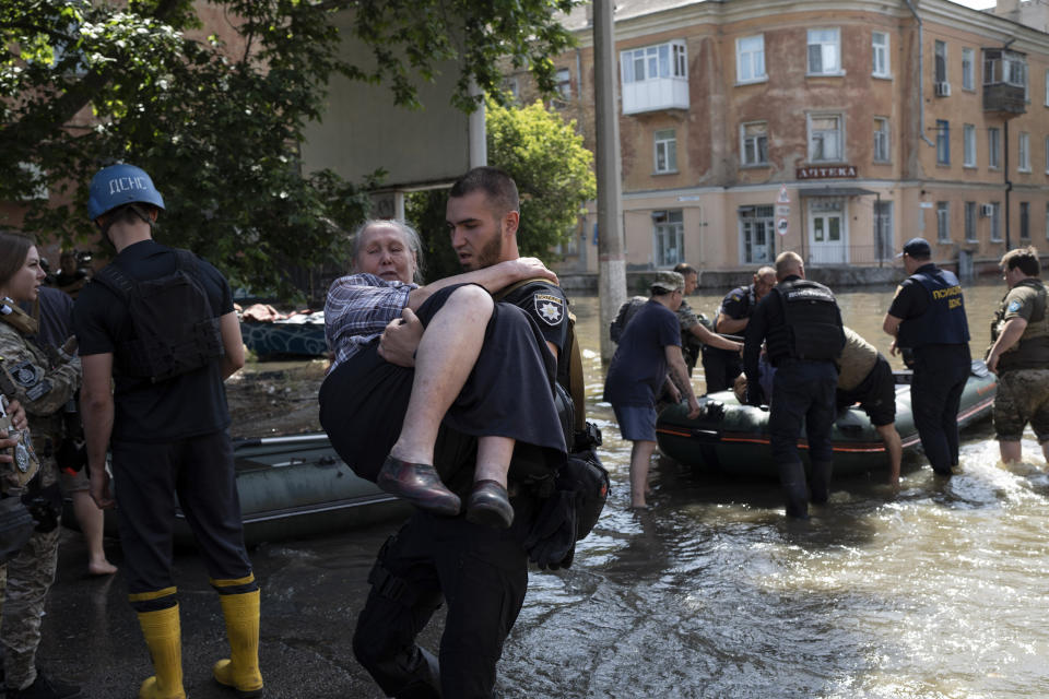 Residents are evacuated from a flooded neighborhood in Kherson, Ukraine, Wednesday, June 7, 2023 after the Kakhovka dam was blown up. Residents of southern Ukraine braced for a second day of swelling floodwaters on Wednesday as authorities warned that a Dnieper River dam breach would continue to unleash pent-up waters from a giant reservoir. (AP Photo/Roman Hrytsyna)