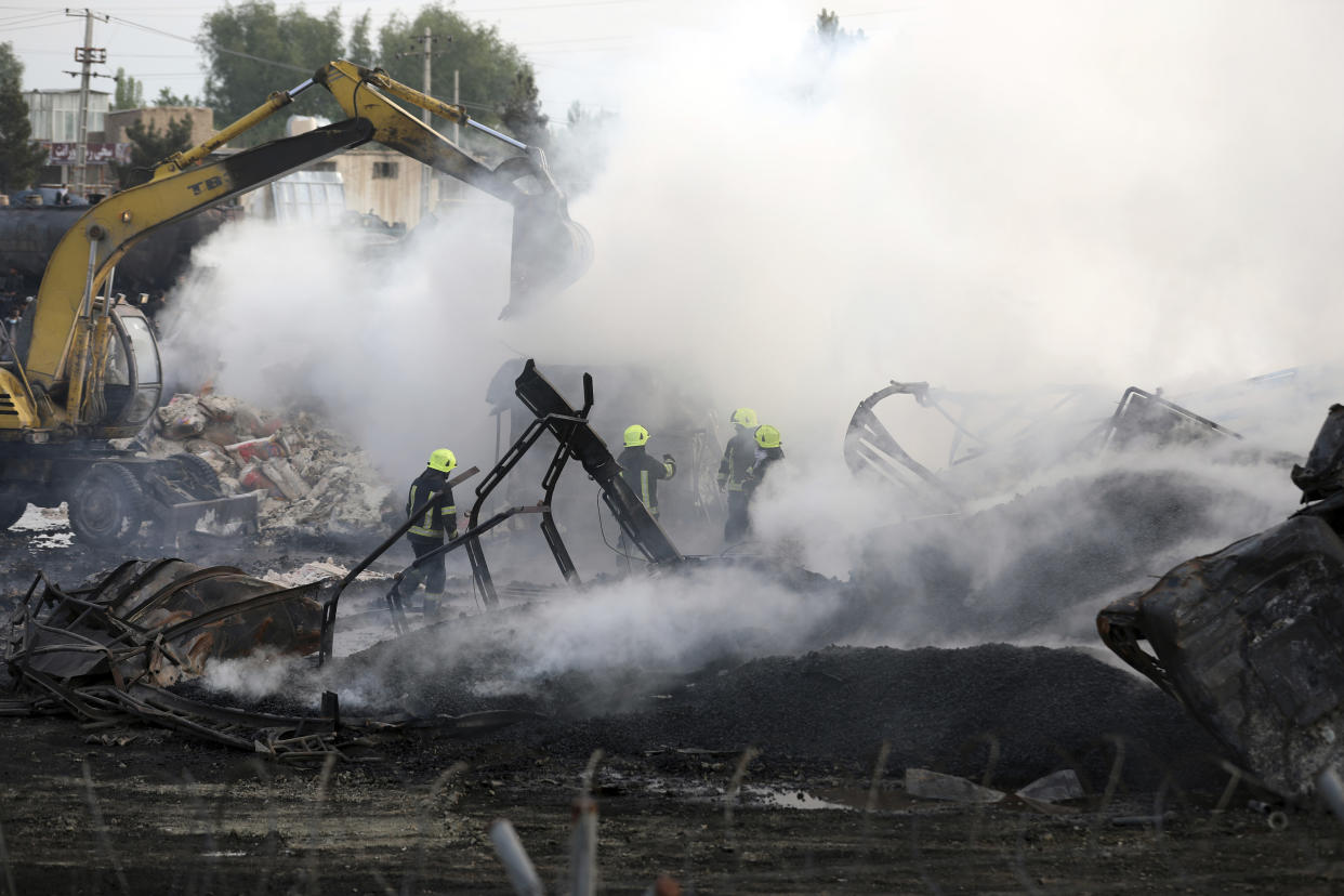 Firefighters work to extinguish a burning fuel tanker in Kabul, Afghanistan, Sunday, May 2, 2021. A fire roared through several fuel tankers on the northern edge of the Afghan capital late Saturday, injuring at least 10 people and plunging much of the city into darkness, officials said. (AP Photo/Rahmat Gul)