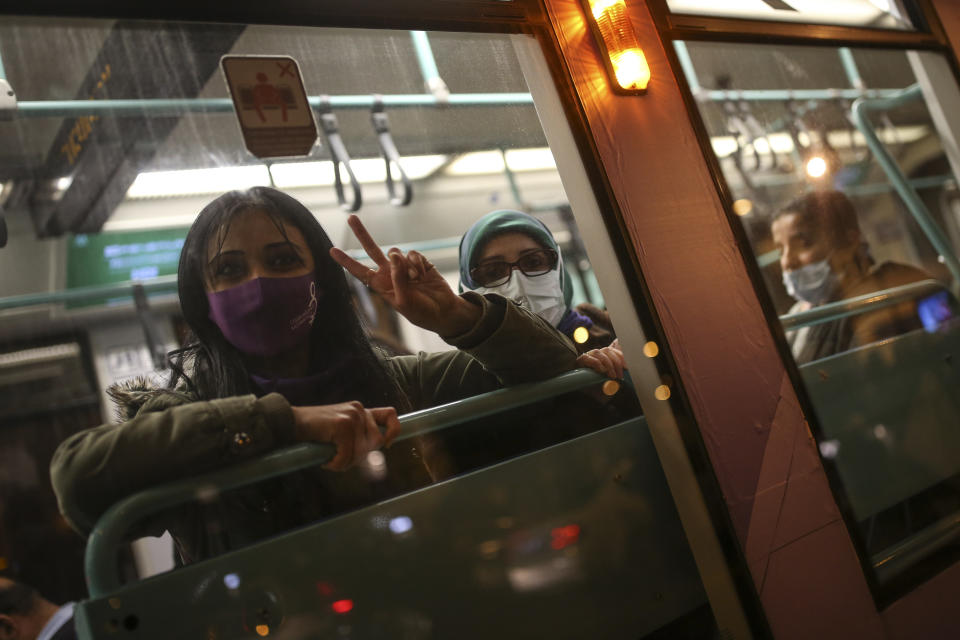 A protester flashes the V-sign from inside a bus during a rally to mark International Women's Day in Istanbul, Monday, March 8, 2021.Thousands of people joined the march to denounce violence against women in Turkey, where more than 400 women were killed last year. The demonstrators are demanding strong measures to stop attacks on women by former partners or family members as well as government commitment to a European treaty on combatting violence against women. (AP Photo/Emrah Gurel)