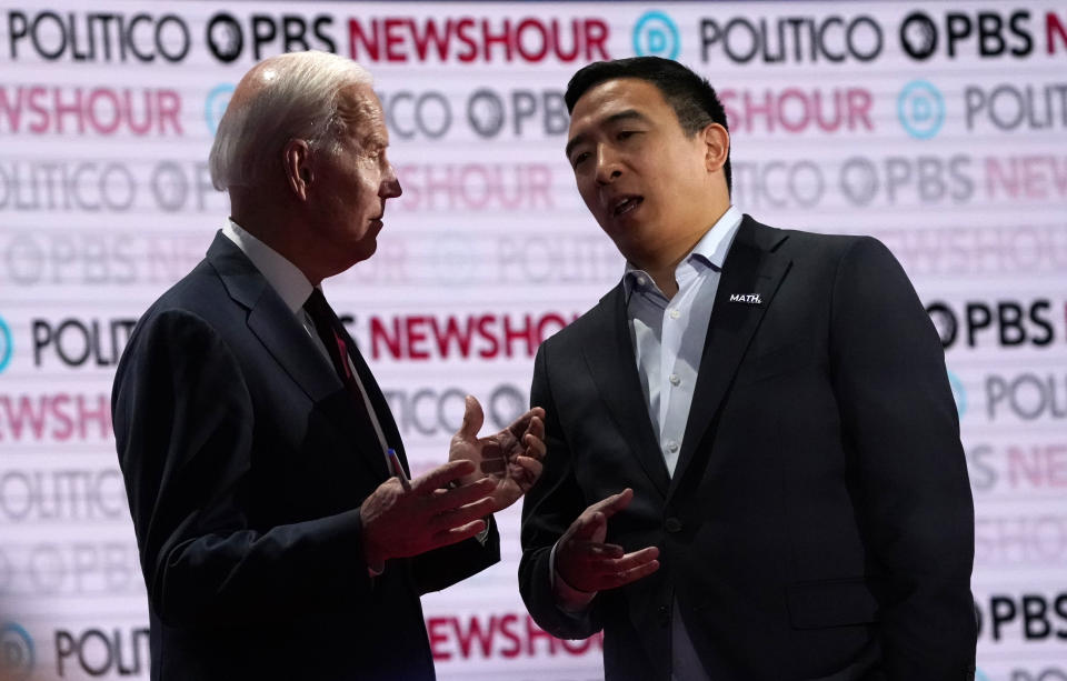 Democratic U.S. presidential candidates entrepreneur Andrew Yang (R) speaks with former Vice President Joe Biden during a break at the 2020 campaign debate at Loyola Marymount University in Los Angeles, California, U.S., December 19, 2019. REUTERS/Mike Blake