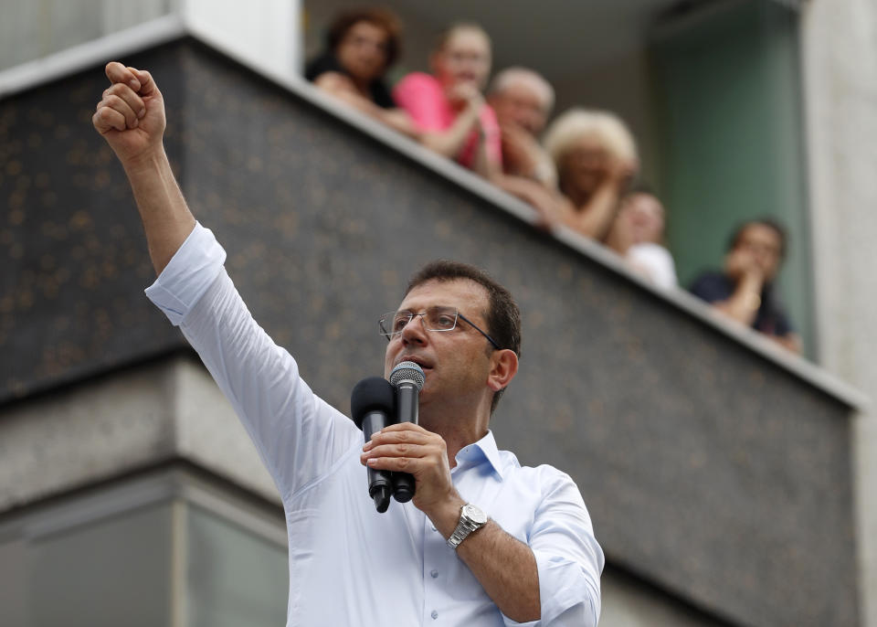 In this Wednesday, June 19, 2019 photo, Ekrem Imamoglu, candidate of the secular opposition Republican People's Party, or CHP, waves to supporters as he speaks at a rally in Istanbul, ahead of the June 23 re-run of Istanbul elections. The 49-year-old candidate won the March 31 local elections with a slim majority, but after weeks of recounting requested by the ruling party, Turkey's electoral authority annulled the result of the vote, revoked his mandate and ordered the new election. (AP Photo/Lefteris Pitarakis)