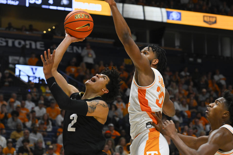 Colorado guard KJ Simpson (2) shoots as Tennessee guard Josiah-Jordan James defends during the second half of an NCAA college basketball game, Sunday, Nov. 13, 2022, in Nashville, Tenn. Colorado won 78-66. (AP Photo/John Amis)