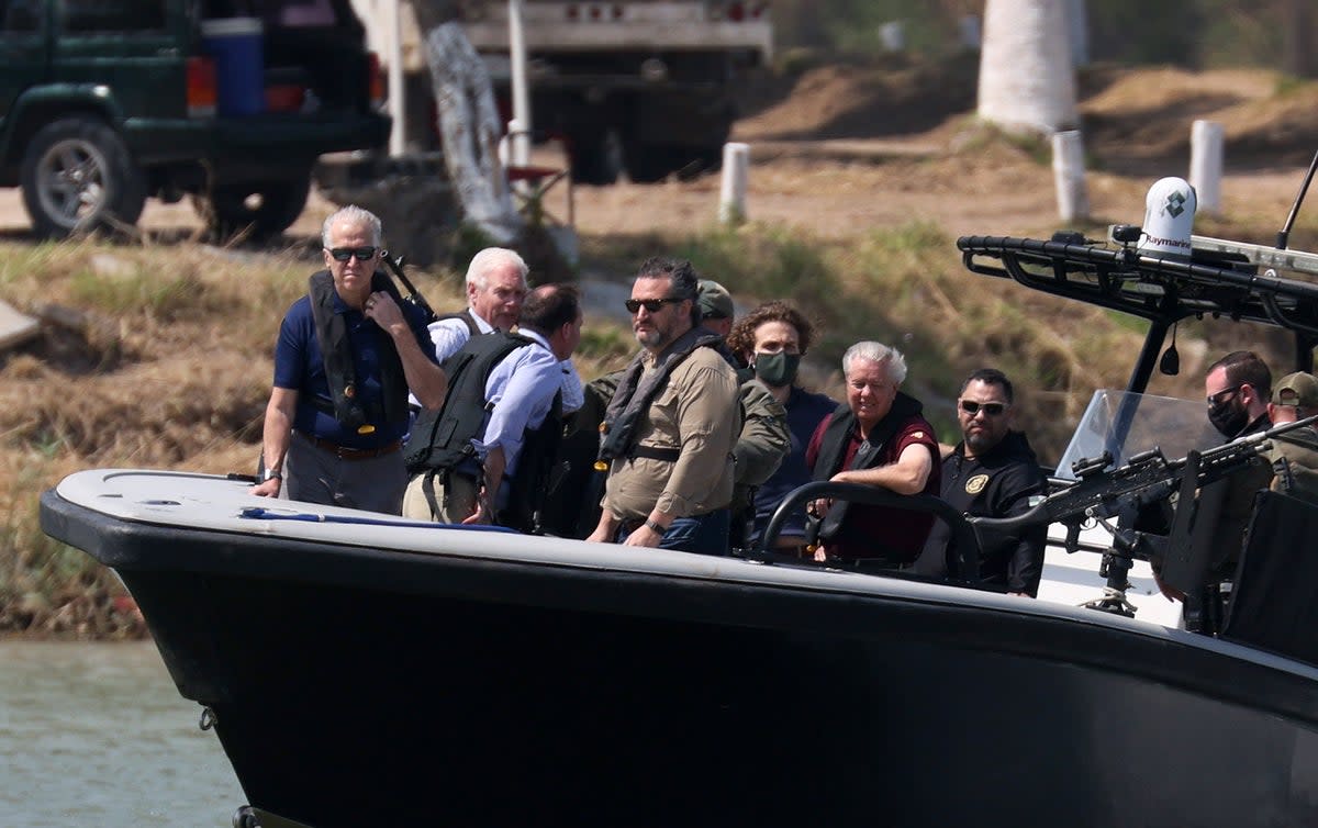 Sen. Ted Cruz (R-TX) and Sen. Lindsey Graham (R-SC) (red shirt) stand aboard a Texas Department of Public Safety boat for a tour of part of the Rio Grande river on March 26, 2021 in Mission, Texas. (Getty Images)