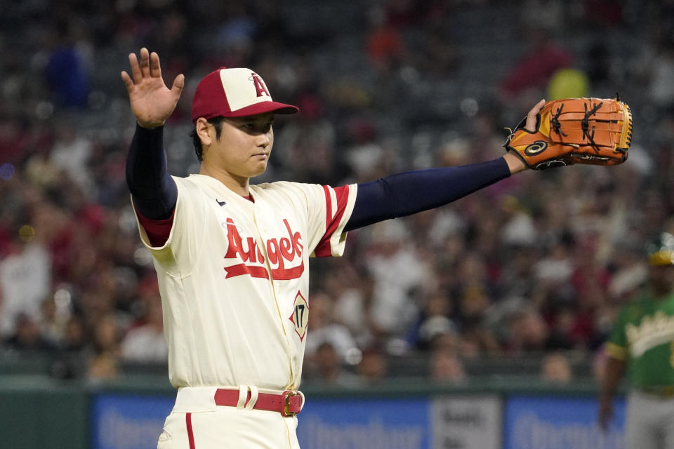 Los Angeles Angels starting pitcher Shohei Ohtani reacts as catcher Max Stassi makes a catch on a foul ball hit by Oakland Athletics' Seth Brown during the eighth inning of a baseball game Thursday, Sept. 29, 2022, in Anaheim, Calif. (AP Photo/Mark J. Terrill)