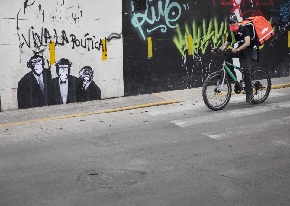 A piece of street art shows three chimps dressed in suits and a spray painted message that reads in Spanish: "Long live politics!" in Lima, Peru, Friday, Sept. 18, 2020. Peruvian President Martin Vizcarra’s job is on the line Friday as opposition lawmakers push through an impeachment hearing criticized as a hasty and poorly timed ouster attempt in one of the countries hardest hit by the new coronavirus pandemic. (AP Photo/Rodrigo Abd)