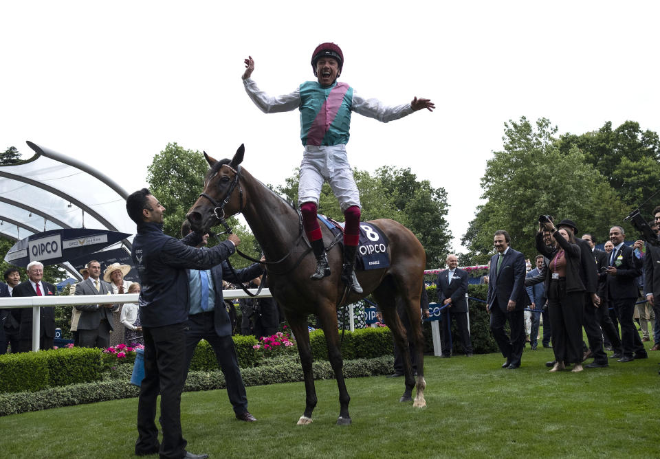 Frankie Dettori jumps from Enable after winning The King George VI and Queen Elizabeth Stakes during QIPCO King George Day at Ascot Racecourse.