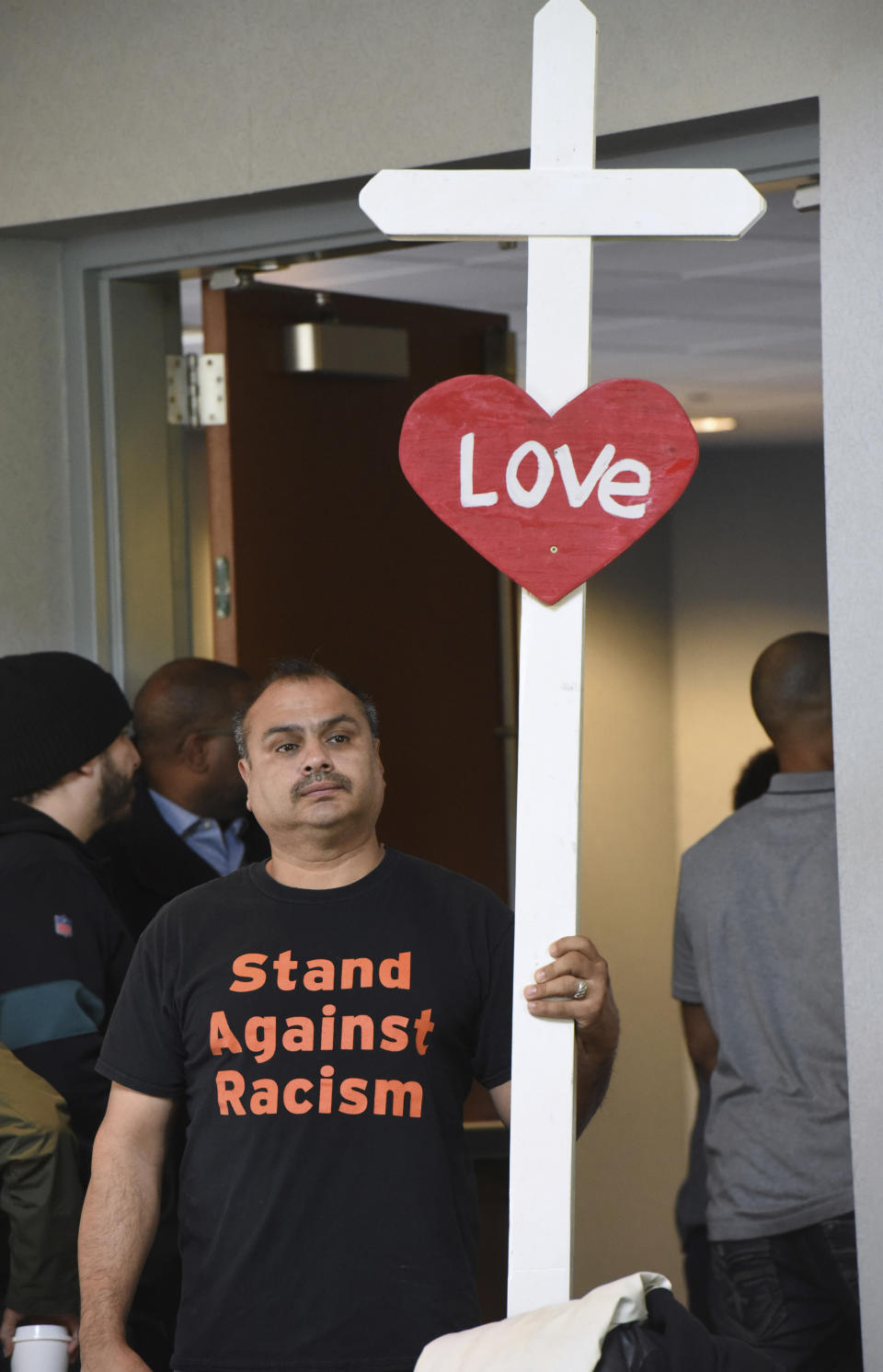 Aurora, Ill. resident Casildo Cuevas shows support of the families involved in an incident at a Naperville, Ill. Buffalo Wild Wings restaurant during a press conference Tuesday, Nov 5, 2019 in Aurora, Ill. (Paul Valade/Daily Herald via AP)