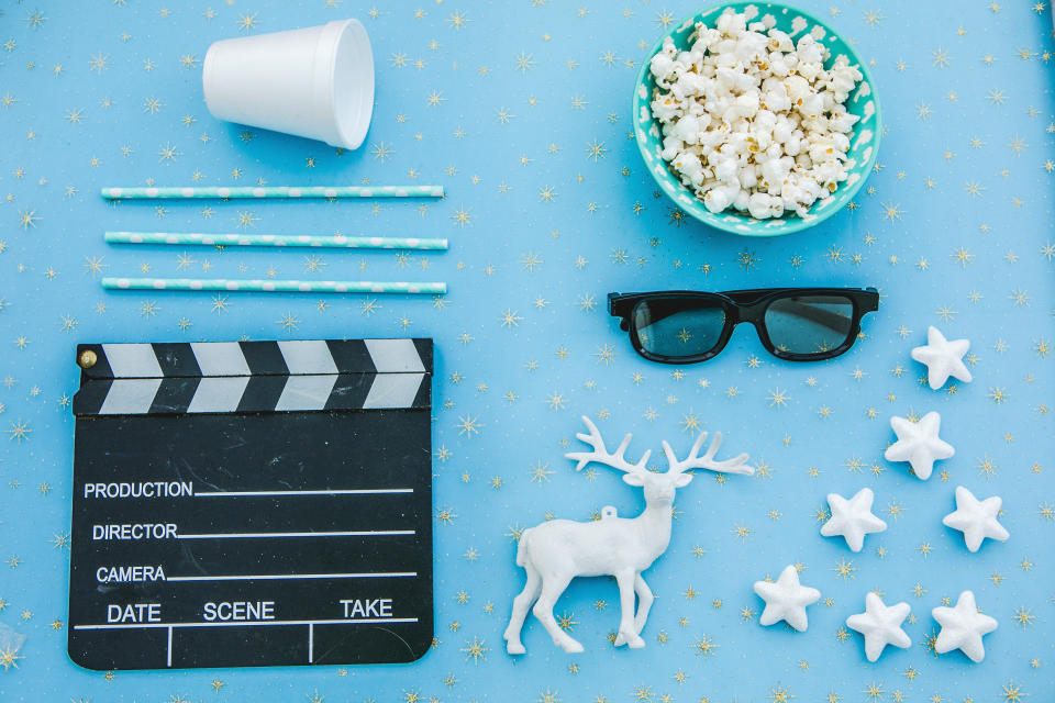 movie tickets, clapperboard, pop corn and 3d glasses in a red frame background..Flat lay .Christmas concept