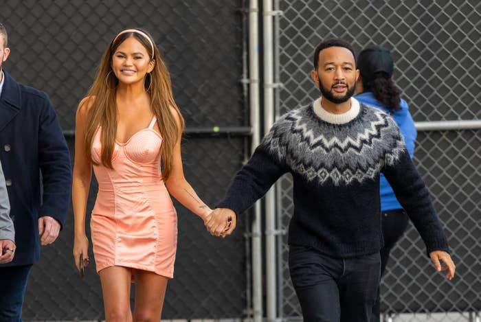 Chrissy Teigen and John Legend holding hands outside