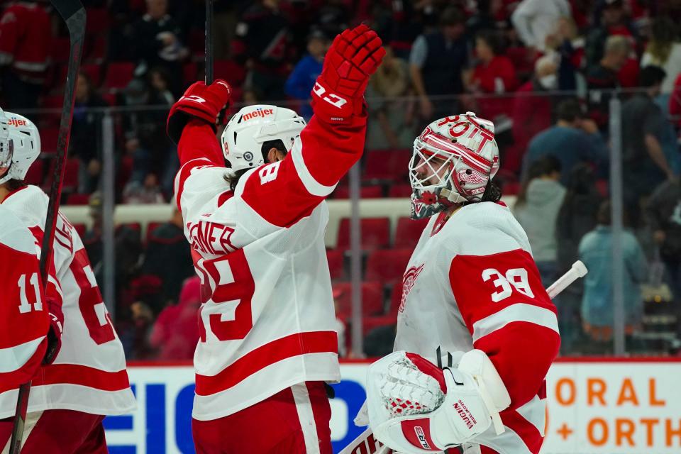 Detroit Red Wings goaltender Alex Nedeljkovic (39) and center Sam Gagner (89) celebrate their victory against the Carolina Hurricanes at PNC Arena in Raleigh, North Carolina, on Thursday, April 14, 2022.