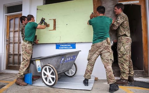 40 Commando Assault Engineers boarding up windows at Road Town Police Station in the British Virgin Islands - Credit: LPhot Joel Rouse /EPA