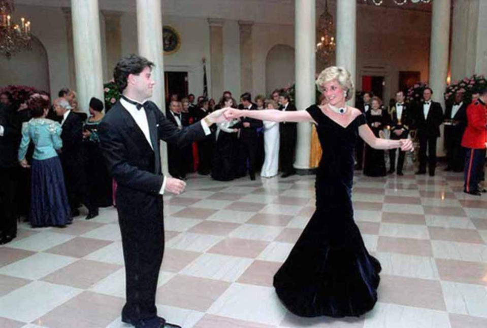 <p>Princess Di was the belle of the ball at the White House in the mid-80s in an off-the-shoulder velvet ballgown. This photo, depicting John Travolta spinning the royal around the dance floor, showed just how beautiful the fishtail skirt design was. <i>[Photo: Rex]</i></p>