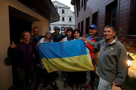 Orthodox pilgrims from Ukraine holding a national flag, react after a statement following the Synod meeting at the Ecumenical Orthodox Patriarchate in Istanbul, Turkey October 11, 2018. REUTERS/Murad Sezer