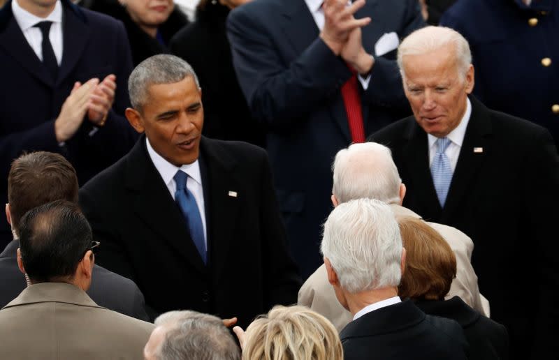 FILE PHOTO: U.S. President Barack Obama and Vice President Joe Biden talk to guests at the inauguration ceremonies swearing in Donald Trump as the 45th president of the United States on the West front of the U.S. Capitol in Washington