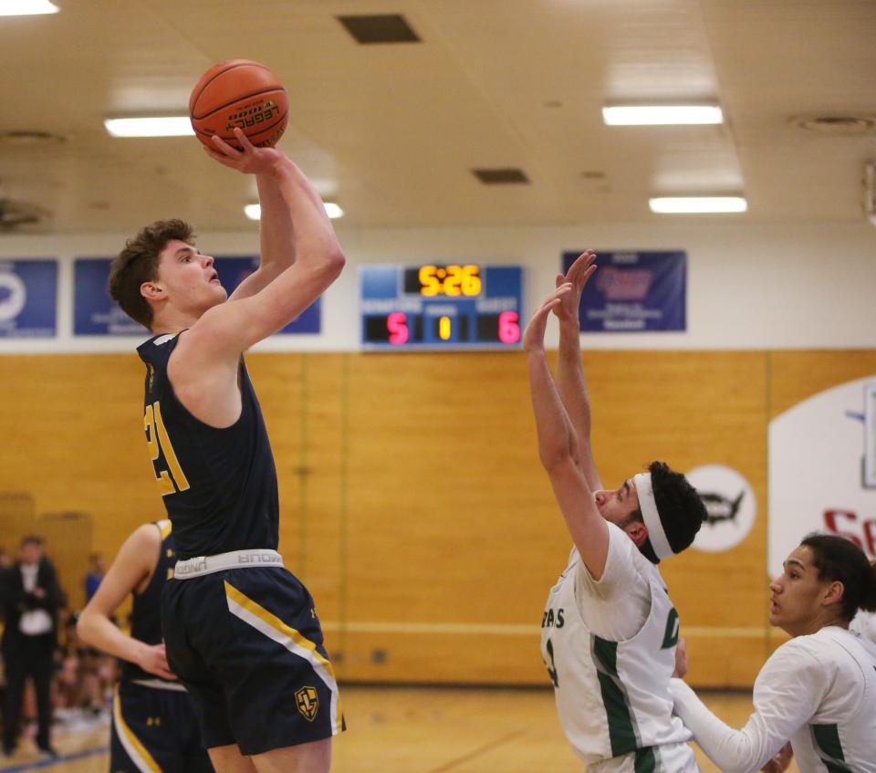 Lourdes' Parick Faughnan goes for a jump shot overSpackenkill's Sanad Sahawneh during the MHAL boys basketball final on February 23, 2023. 