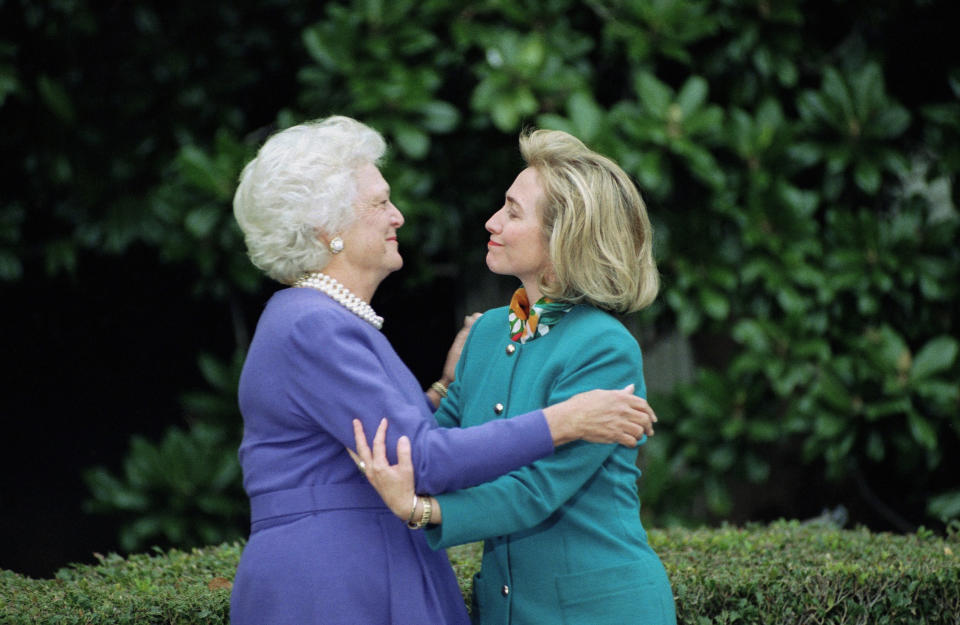 FILE - First lady Barbara Bush greets first lady-to-be Hillary Clinton upon her arrival at the White House in Washington Nov. 19, 1992. Mrs. Bush brushed cheeks with Mrs. Clinton, took her by the hand and offered some ready advice about the news media as she took her on a tour of her new home-to-be. (AP Photo/Ron Edmonds, File)