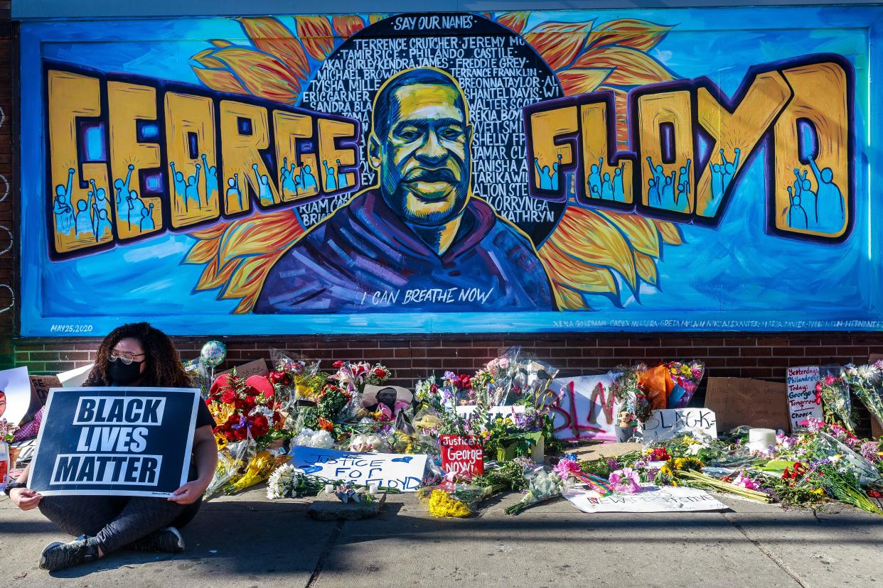 <p> Flowers, signs and balloons are left near a makeshift memorial to George Floyd near the spot where he died while in custody of the Minneapolis police, on May 29, 2020 in Minneapolis, Minnesota</p> (Photo by KEREM YUCEL/AFP via Getty Images)