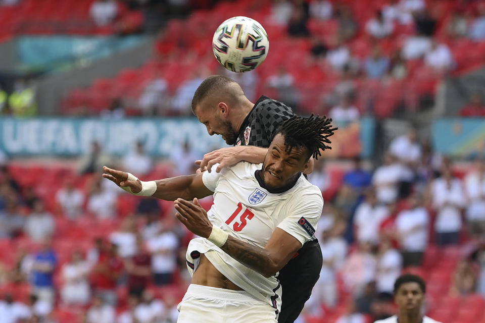 England's Tyrone Mings and Croatia's Ante Rebic, top, jump for the ball during the Euro 2020 soccer championship group D match between England and Croatia, at Wembley stadium, London, Sunday, June 13, 2021. (Laurence Griffiths, Pool via AP)