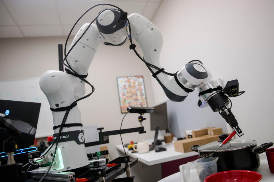 Heng Wey, an undergraduate student, manipulates a robotic arm to scoop coffee beans with a spoon at the Mila Quebec AI Institute on July 4, 2023, in Montreal, Canada. Mila is a not-for-profit organization whose Scientific Director, Yoshua Bengio, is best known for his work in machine deep learning, artificial neural networks, and most recently, his call to action to regulate AI research. (Photo by ANDREJ IVANOV / AFP) (Photo by ANDREJ IVANOV/AFP via Getty Images)