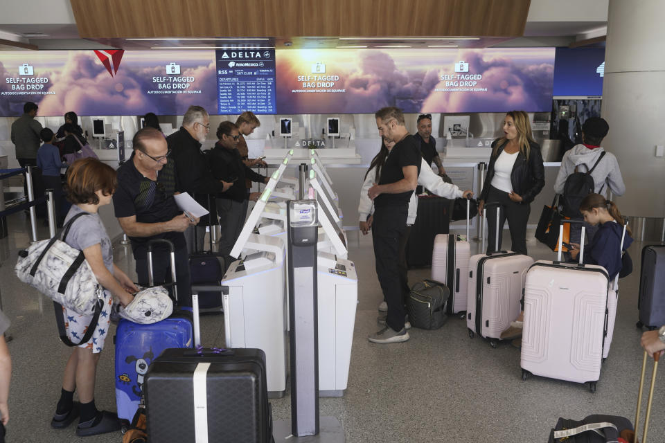 Passengers travel during the week of Thanksgiving, Wednesday, Nov. 22, 2023, at Los Angeles International Airport in Los Angeles. The late crush of holiday travelers is picking up steam, with about 2.7 million people expected to board flights on Wednesday and millions more planning to drive or take the train to Thanksgiving celebrations. (AP Photo/Damian Dovarganes)