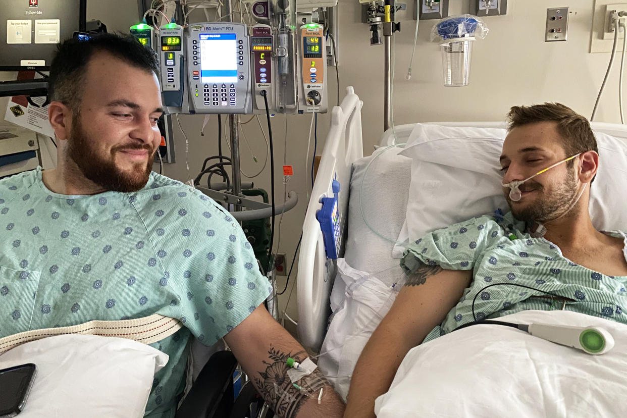 Rafael Diaz, left, and Reid Alexander smile in a hospital room at Indiana University Health Methodist Hospital on Aug. 14, 2021, the day after Diaz donated one of his kidneys to Alexander. (Courtesy Rafael Diaz)