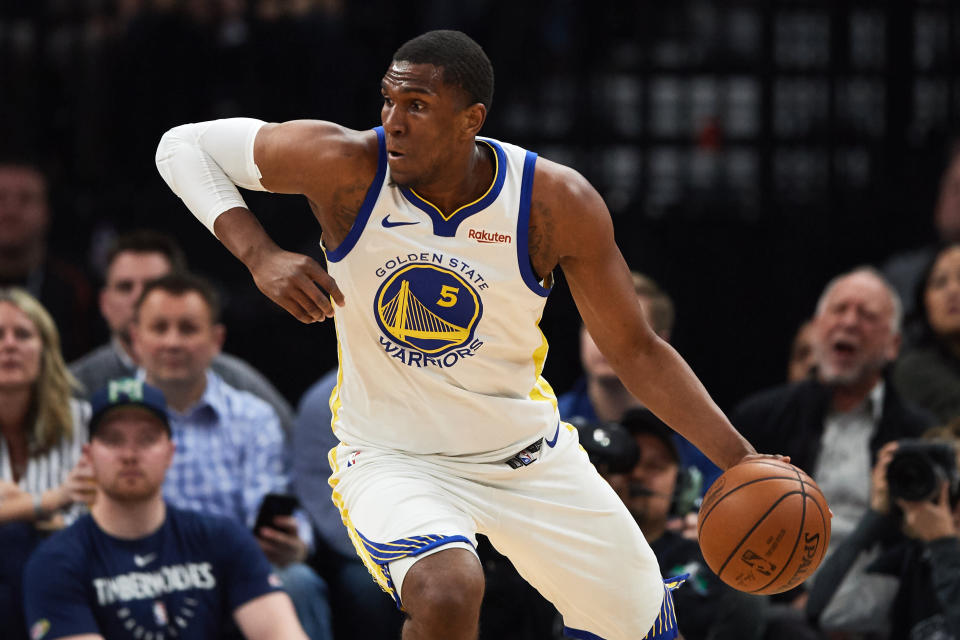 MINNEAPOLIS, MN - MARCH 29: Kevon Looney #5 of the Golden State Warriors dribbles the ball against the Minnesota Timberwolves during the game on March 29, 2019 at the Target Center in Minneapolis, Minnesota. NOTE TO USER: User expressly acknowledges and agrees that, by downloading and or using this Photograph, user is consenting to the terms and conditions of the Getty Images License Agreement. (Photo by Hannah Foslien/Getty Images)