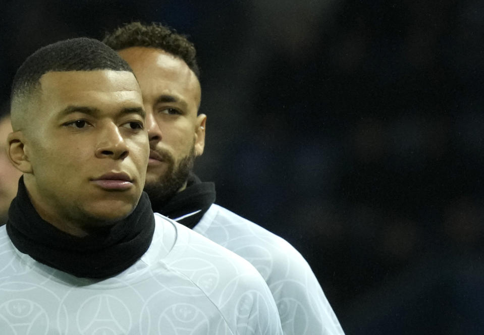 PSG's Kylian Mbappe, front, and PSG's Neymar run during the warm up before the French League One soccer match between Paris Saint-Germain and Strasbourg at the Parc des Princes in Paris, Wednesday, Dec. 28, 2022. (AP Photo/Thibault Camus)