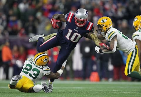 Green Bay Packers cornerback Jaire Alexander (23) and safety Josh Jones (27) tackle New England Patriots wide receiver Josh Gordon (10) during the fourth quarter at Gillette Stadium - Credit: Stew Milne/USA Today